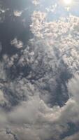 timelapse pluizig cumulus wolken in beweging in helder zonsondergang lucht. abstract antenne natuur zomer oceaan zonsondergang, zee en lucht visie. vakantie, reis, vakantie concept. weer en klimaat Wijzigen. verticaal video