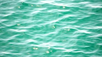 Sea water surface. Aerial view on clear azure sea water. Sun glare. Abstract nautical summer ocean nature. Holiday, vacation and travel concept. Nobody. Slow motion. Weather and climate change video