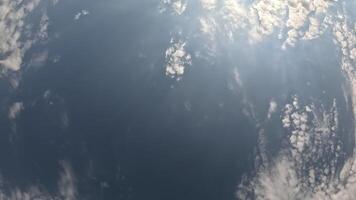 Timelapse fluffy Cirrus clouds moving in bright sunset sky. Abstract aerial nature summer ocean sunset, sea and sky view. Vacation, travel, holiday concept. Weather and Climate Change video