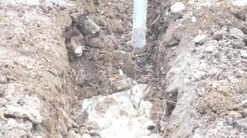 Excavator, trench, stone - Excavator digs stone to create trench on road for new water plastic pipe. construction groundwork. Construction, Infrastructure, development video