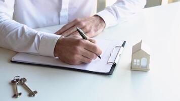 Male realtor signs a contract for the sale of an apartment video