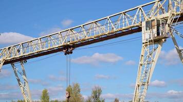 Overhead cranes over railroad in metal pipe outdoor warehouse video