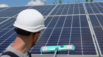 arbetstagare rengör sol- panel med vatten rena på sol- kraft växt video