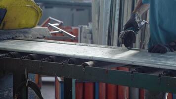 Close-up of busy welder rough grinding metal piece with rotary hand tool in workshop video