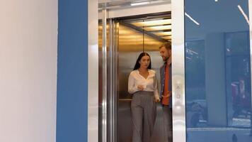 Confident business partners talking leaving the elevator video