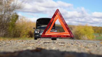 Car with problems and a red triangle to warn other road users. Transportation, traveling concept video