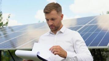 Engineers checking solar panels. Alternative energy ecological concept video