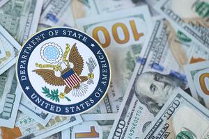 KYIV, UKRAINE - MARCH 9, 2024 US Department of State seal on many US hundred dollar bills photo