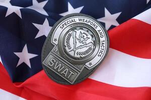 KYIV, UKRAINE - MARCH 9, 2024 US SWAT badge on United States of America flag photo
