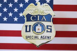 KYIV, UKRAINE - MARCH 9, 2024 US CIA Central Intelligence Agency badge on United States of America flag photo
