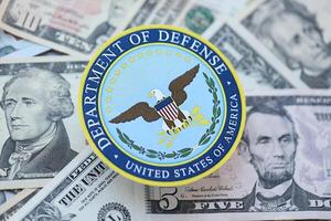 KYIV, UKRAINE - MARCH 9, 2024 US Department of Defense seal on many US dollar bills photo