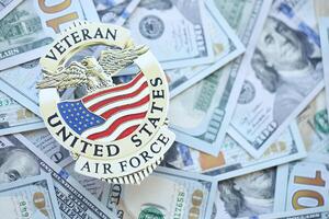 KYIV, UKRAINE - MARCH 9, 2024 US Air Force Veteran badge on many US hundred dollar bills photo