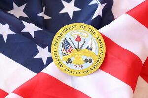 KYIV, UKRAINE - MARCH 9, 2024 US Department of Army seal on United States of America flag photo