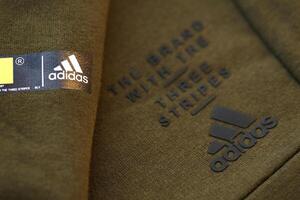 KYIV, UKRAINE - 4 MAY, 2023 Adidas company logo on new brand clothes photo