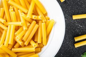 raw pasta tortiglioni cooking appetizer meal food snack on the table copy space food background photo