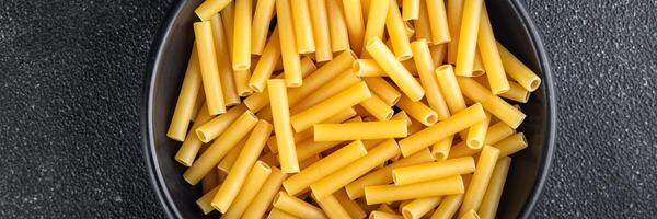 raw pasta tortiglioni cooking appetizer meal food snack on the table copy space food background photo