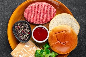 burger set raw cutlet, bun, cheese, tomato sauce, greens fresh cooking appetizer meal food snack on the table copy space food background rustic photo