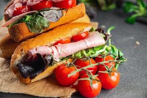 sandwich ham, tomato, green lettuce healthy eating cooking appetizer meal food snack on the table copy space food background rustic top view photo