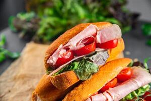 sandwich ham, tomato, green lettuce healthy eating cooking appetizer meal food snack on the table copy space food background rustic top view photo