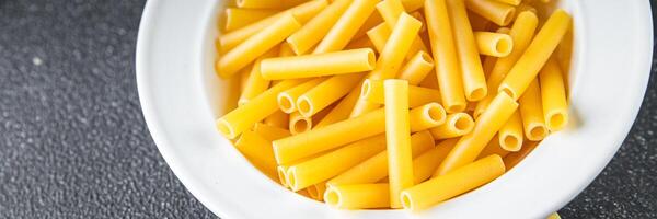 raw pasta tortiglioni cooking appetizer meal food snack on the table copy space food background photo