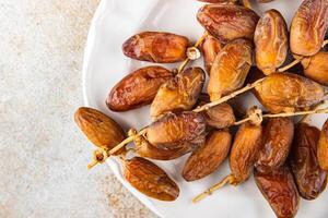 date branch dried sweet fruit fresh meal food snack on the table copy space food background rustic photo