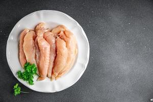 raw chicken meat aiguillettes fresh cooking appetizer meal food snack on the table copy space food background rustic top view keto or paleo diet photo
