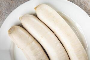 carne blanco salchicha weisswurst bávaro salchichas Cocinando aperitivo comida comida bocadillo en el mesa foto