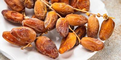 date on a branch dried sweet fruit fresh meal food snack on the table copy space food background photo