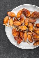 date on a branch dried sweet fruit fresh meal food snack on the table copy space food background photo