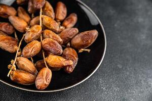 date on a branch dried sweet fruit fresh meal food snack on the table copy space food background photo