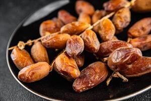 date on a branch dried sweet fruit fresh meal food snack on the table copy space food background photo