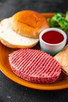 raw burger set cutlet, bun, cheese, tomato sauce, greens fresh cooking meal food snack on the table copy space food background photo