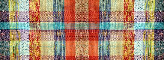 Antique handmade homespun carpet. The texture of an antique rug made of multicolored strips of fabric photo