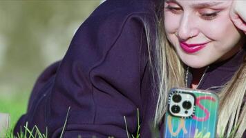 Young Woman is Using her Mobile Phone in Nature video