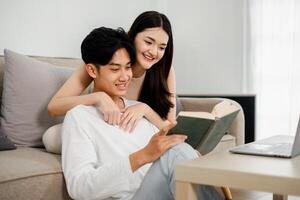Couple enjoys a peaceful reading session together on a sofa, symbolizing shared interests and a comfortable domestic life. photo
