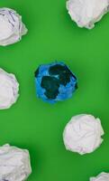 Planet earth made of paper on Green Background photo