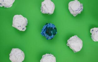 Group of Crumpled Paper on Green Background. Earth day concept. photo