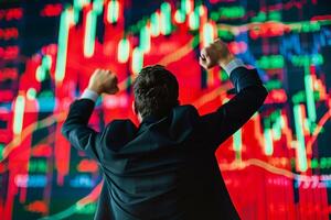 Back view of successful trader in front of stock market board photo