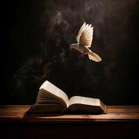 Flying dove above an opened book. The Holy spirit appears over the Bible photo