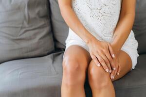 Knee joint pain of woman. Concept of osteoarthritis, rheumatoid arthritis or ligament injury photo