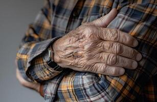 Hand of elder man. Concept of rheumatoid arthritis, osteoarthritis, or joint pain. photo