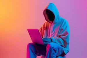 Fashionable anonymous hacker typing computer laptop. Cybercrime, cyberattack, dark web concept. photo