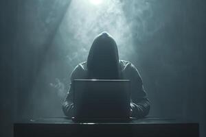 Anonymous hacker typing computer laptop. Cybercrime, cyberattack, dark web concept. photo