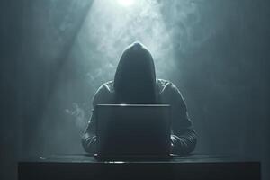 Anonymous hacker typing computer laptop. Cybercrime, cyberattack, dark web concept. photo