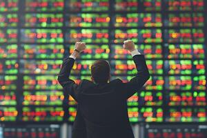 Back view of successful trader in front of stock market board photo