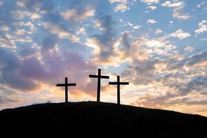 Three christian crosses on the mountain at sunrise, the crucifixion of Jesus Christ photo