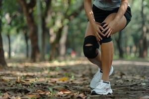 Knee joint pain in Sportswoman in the park photo