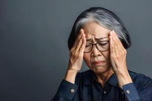 Asian elder woman suffering dizziness, vertigo, headache, fainting attack or stress. photo