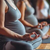 Pregnancy women group doing yoga photo