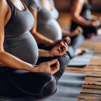 Pregnancy women group doing yoga photo